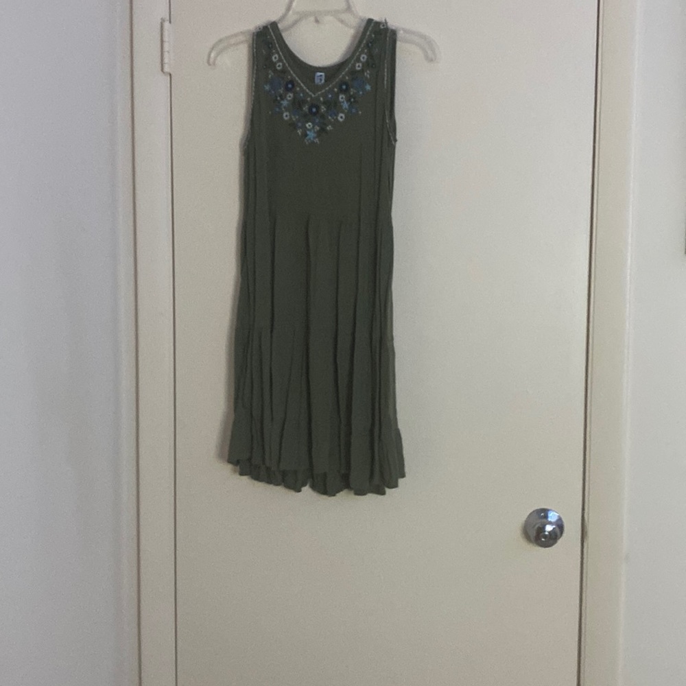 A green dress with little flowering detail at the top of the dress